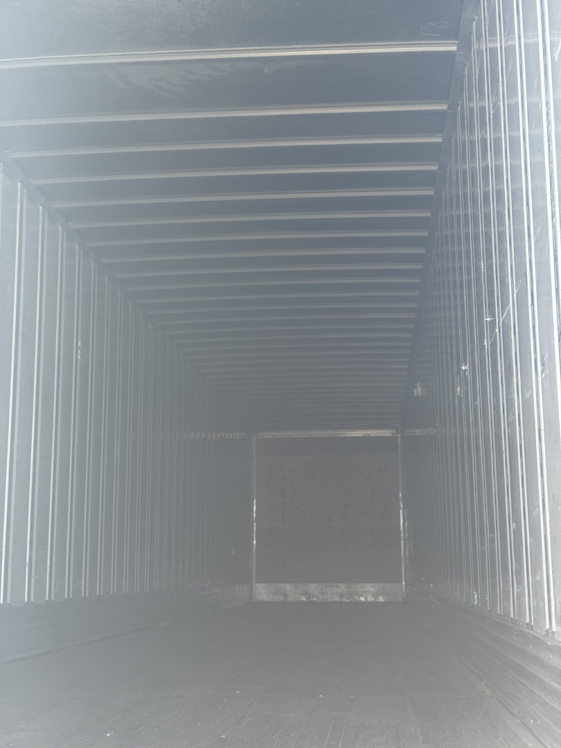 Trailer interior showing cargo space of a 2014 Utility 4000D-X trailer with metal ribbed walls and a dark rear doorway.