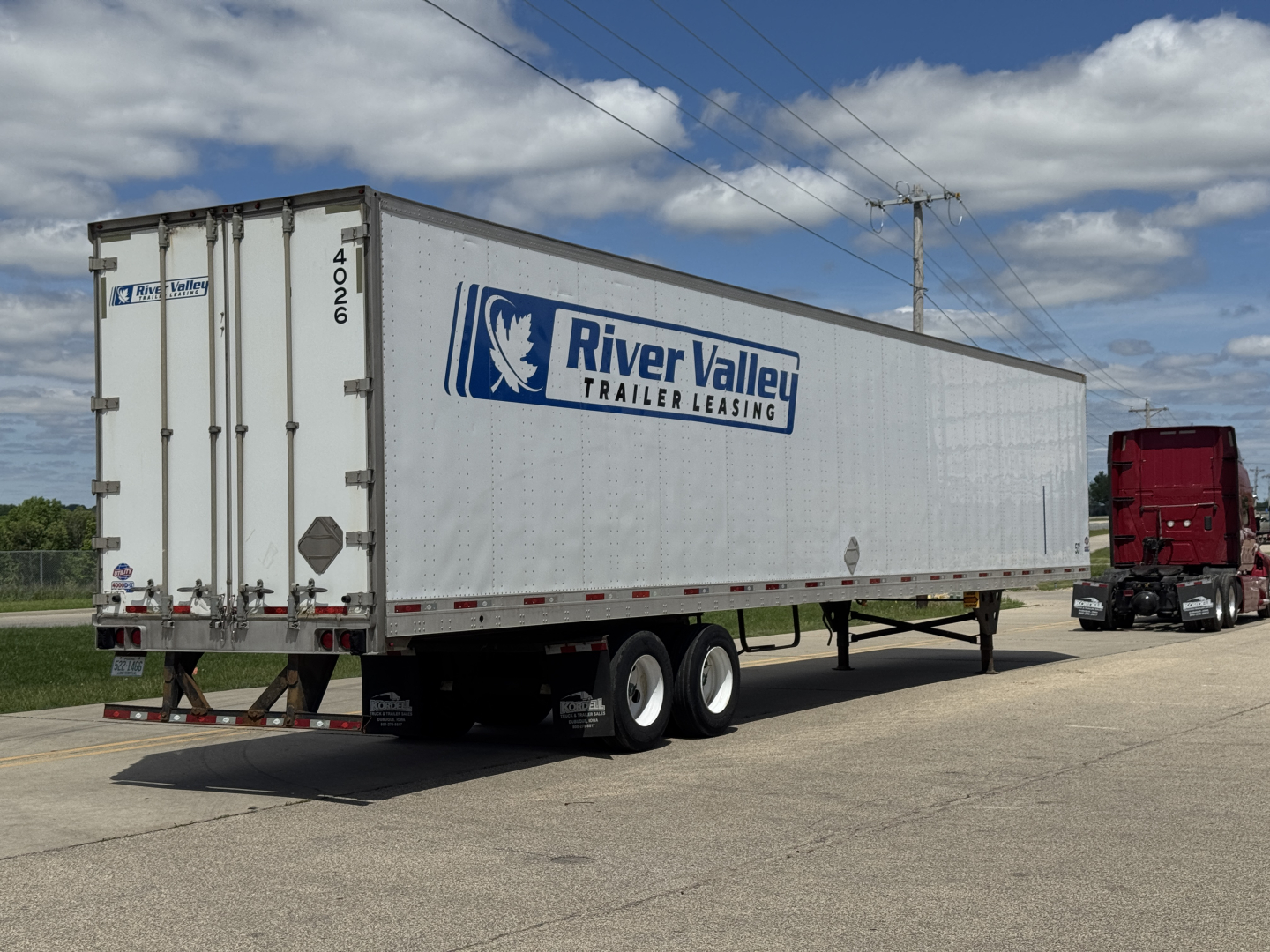 Trailer side view showing River Valley Leasing logo on a white 40-foot utility trailer with tandem axles and rear doors.
