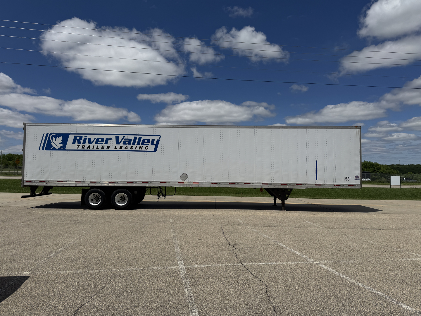 Trailer side view showing River Valley Trailers Leasing logo on a white 53' trailer with dual rear axles and landing gear.