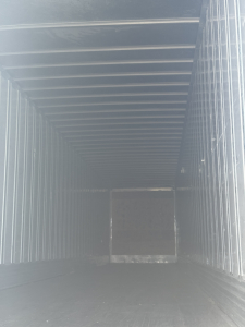 Trailer interior showing cargo space of a 2014 Utility 4000D-X trailer with metal ribbed walls and a dark rear doorway.
