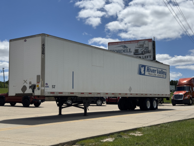 Used 2014 Utility 4000D-X trailer with River Valley logo, side view showing dual-axle configuration and rear doors, VIN tag not visible.