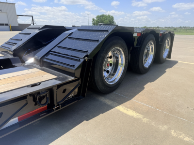 Alpha A110HDG-SF-18" LDH lowboy trailer showing dual rear axles with chrome wheels and textured fenders.