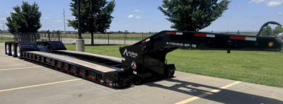 LDH lowboy trailer showing 26' deck with multiple axles and black color. Side text reads A110HDG-SF-18" LDH and welding details near hitch. Lot in background and clear sky.
