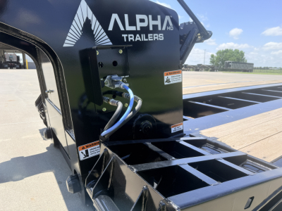 Alpha Trailers A110HDG-SF 18 inch LDH lowboy trailer with hydraulic attachment and blue hoses, Alpha Trailers logo on black steel housing, flatbed deck visible