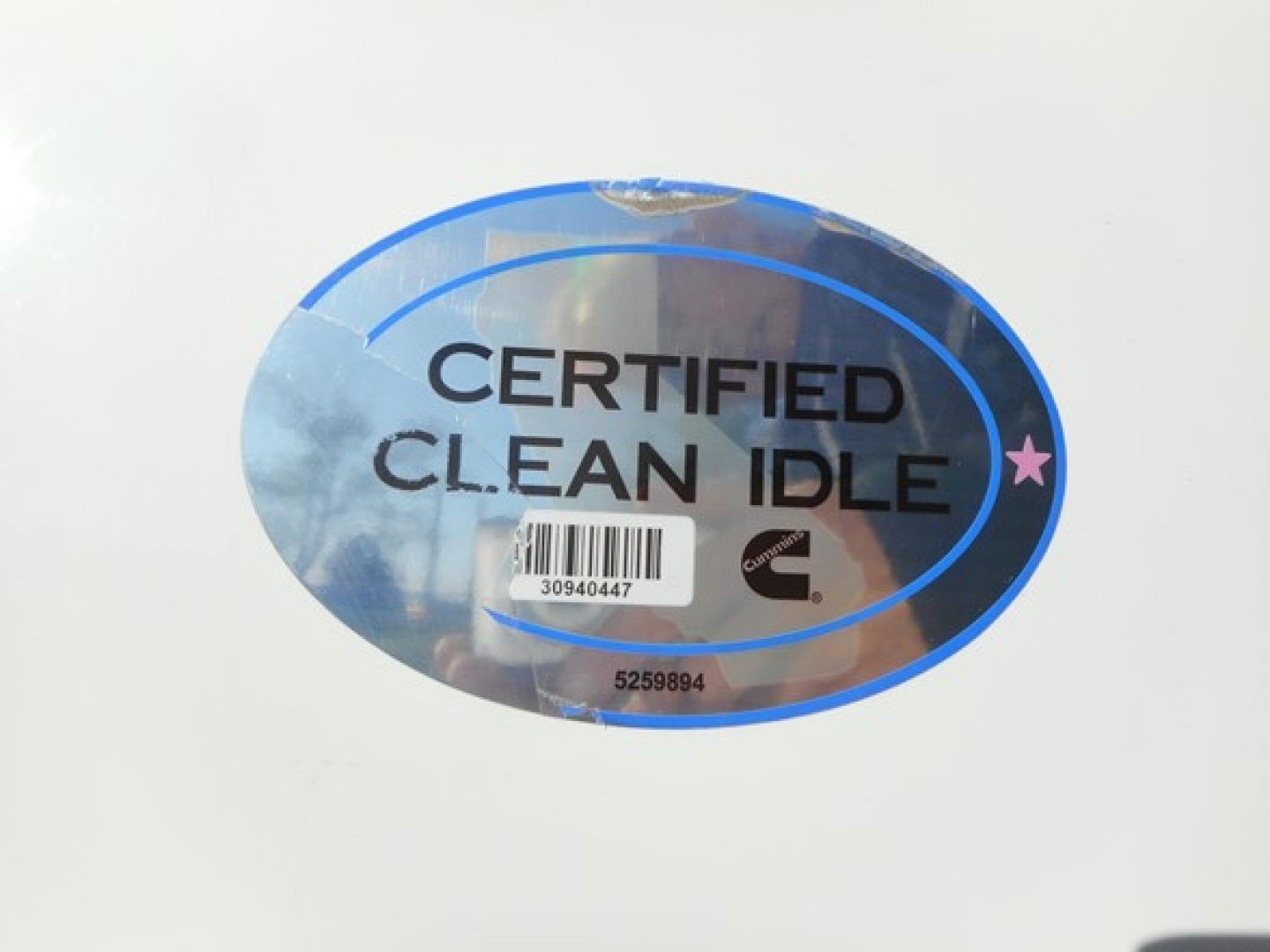 Sticker reading CERTIFIED CLEAN IDLE with barcode on a white surface, likely part of a used Freightliner Cascadia listing.