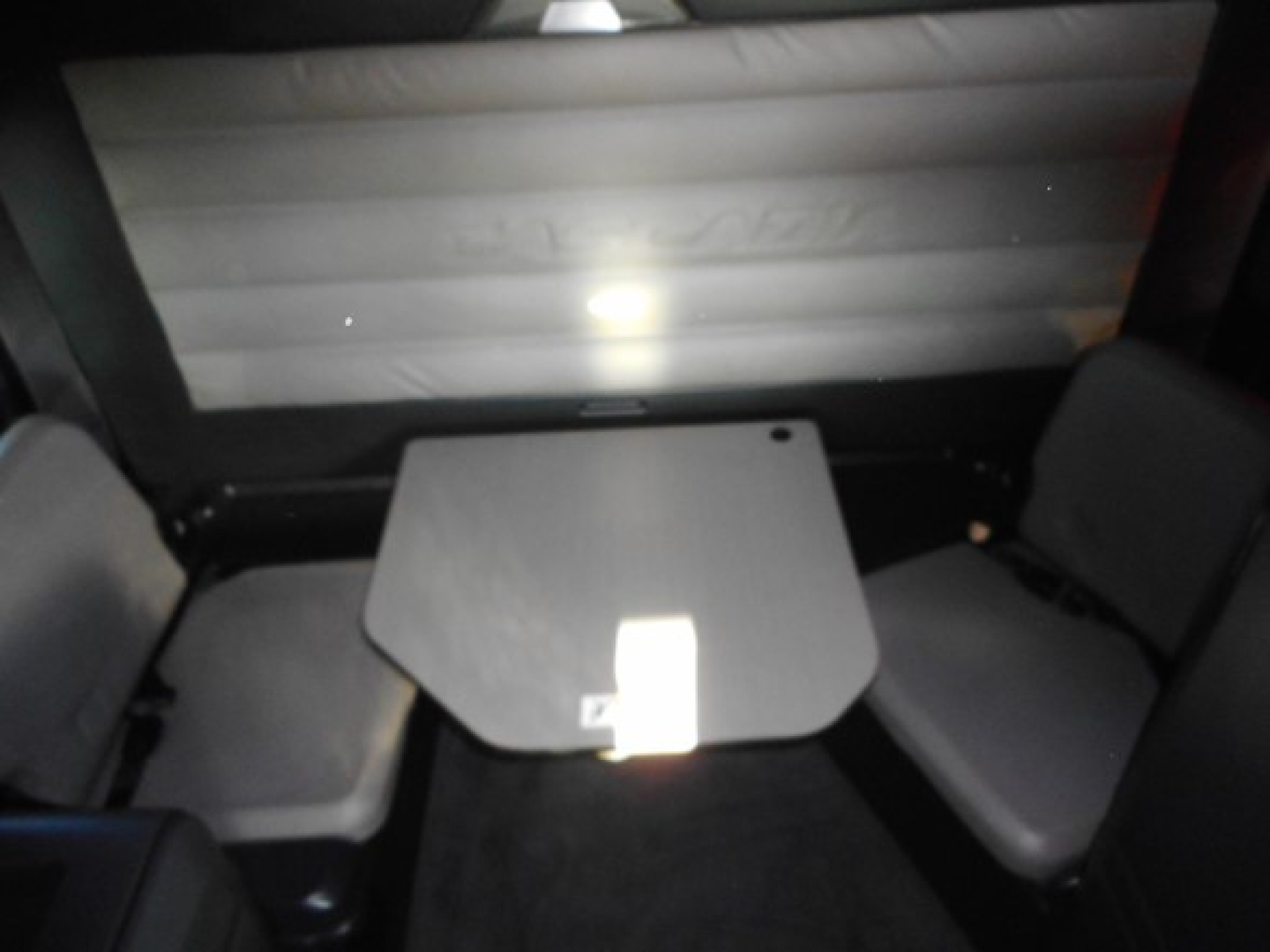 Interior of 2019 Freightliner Cascadia 126 sleeper showing small table and seating area.