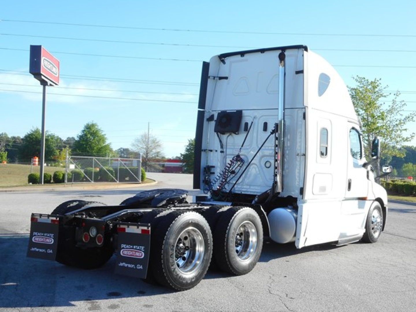 Freightliner Cascadia 126 tractor cab rear side showing fifth wheel and dual rear axles.