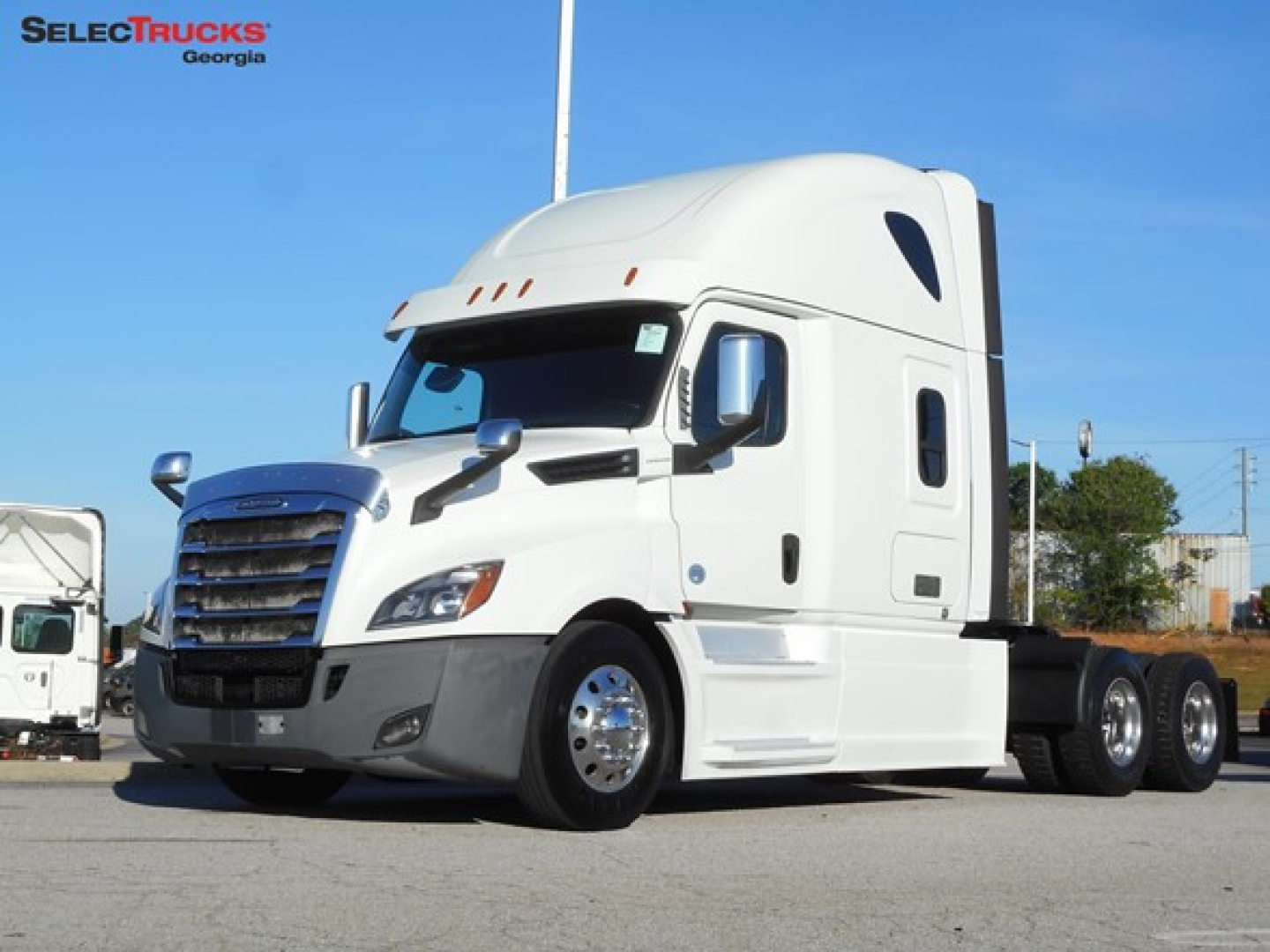 Freightliner Cascadia 126 semi-truck in white, angled view, sleeper cab, with chrome grille and dual rear axles.