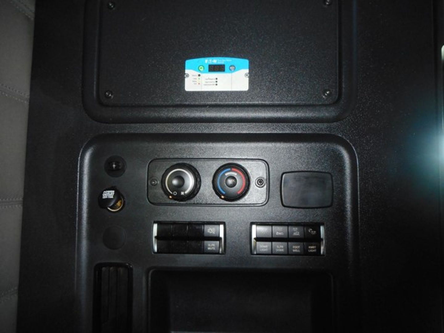 Dashboard controls in Freightliner Cascadia with climate and radio controls visible