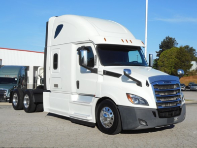 Freightliner Cascadia 126 sleeper cab tractor viewed from front-left showing white exterior, chrome grille, and badge area.