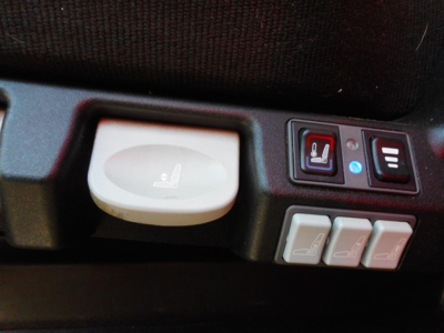 Seat controls on Freightliner Cascadia dash with heated seat switch and three window/seat adjustment buttons.