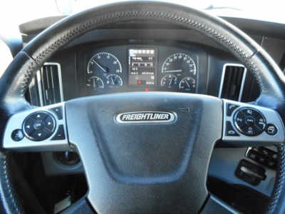 Freightliner Cascadia steering wheel and dashboard showing instrument cluster and controls