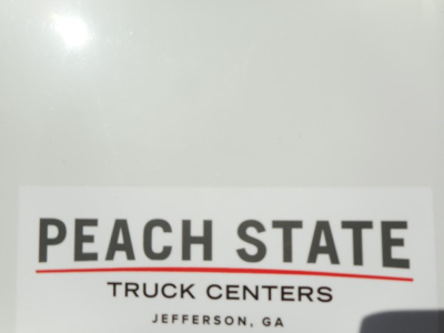 Peach State Truck Centers sticker on white surface showing Peach State Truck Centers Jefferson, GA.