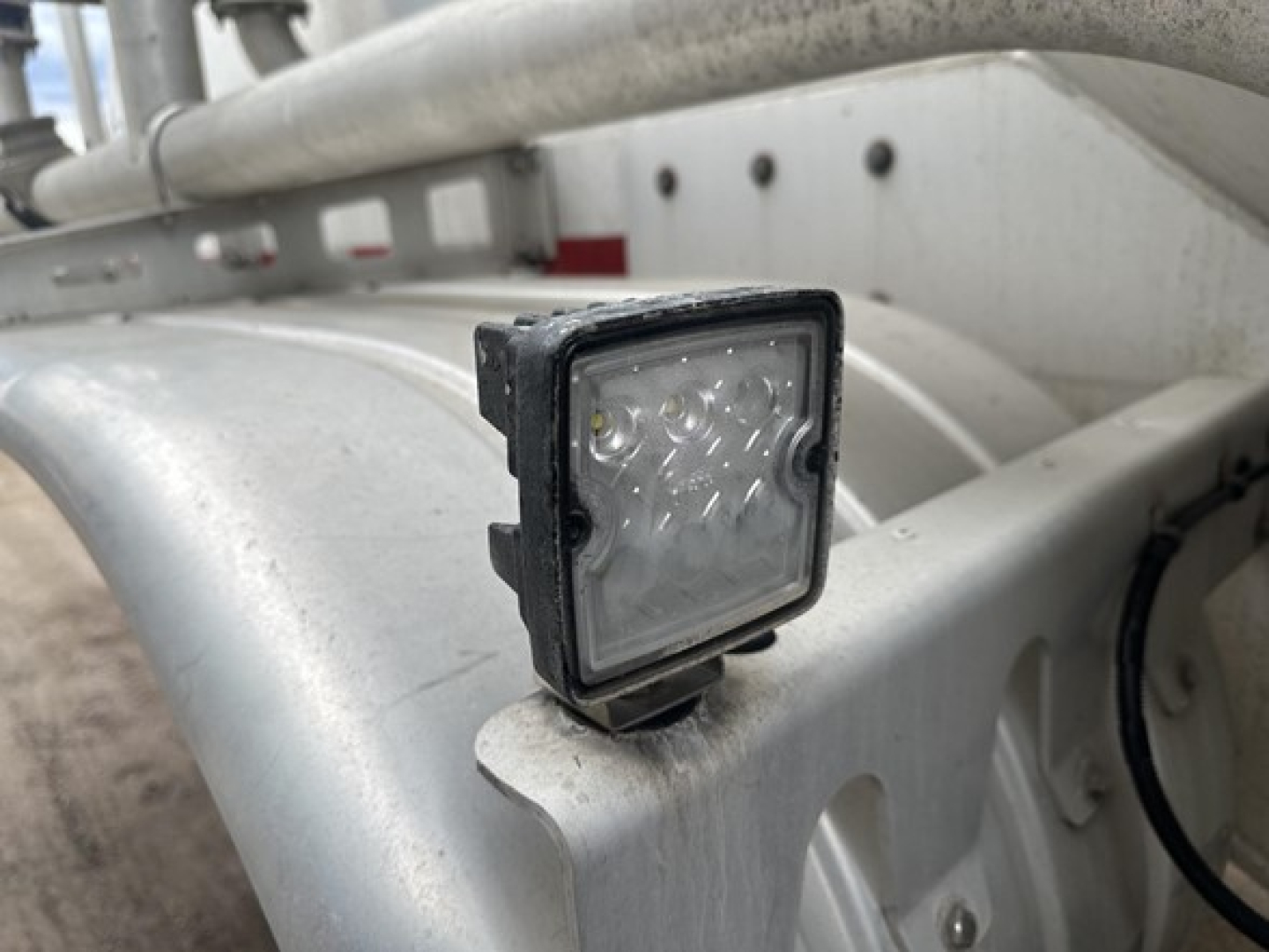 Trailer lighting LED work light mounted on aluminum frame of pneumatic dry bulk trailer.