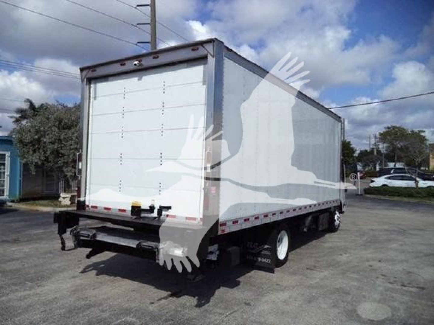 Isuzu NPR-style box truck in-view rear angle showing white cargo box and dual rear wheels