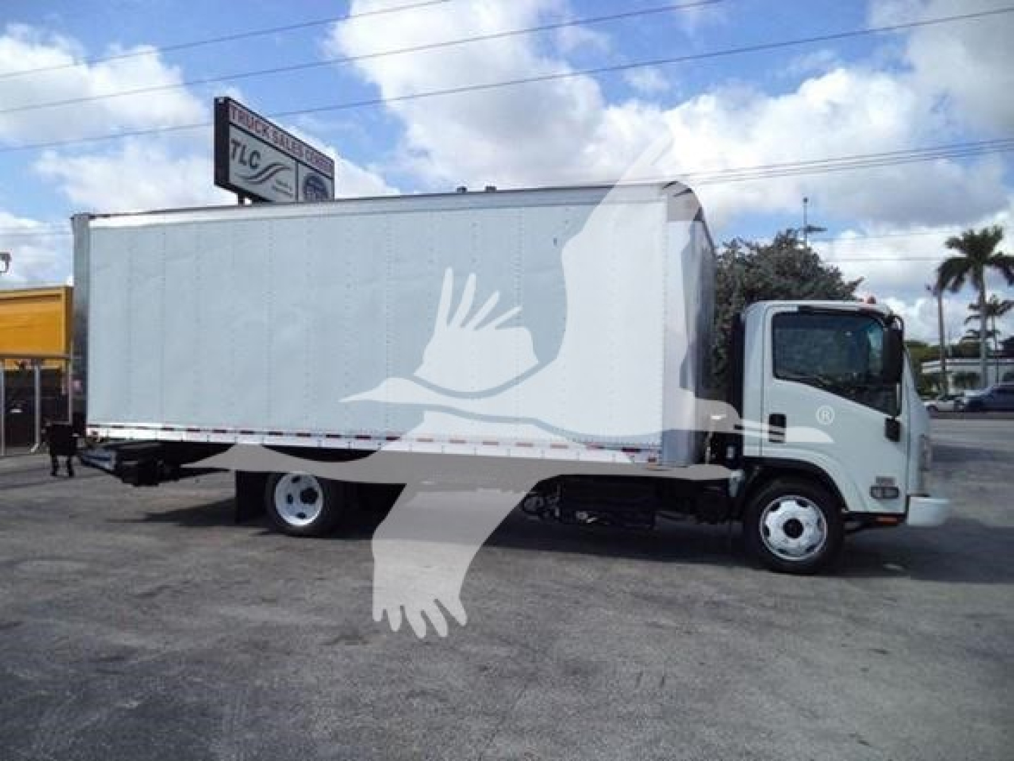Isuzu NPR box truck side view showing a cargo box with cab and wheels.