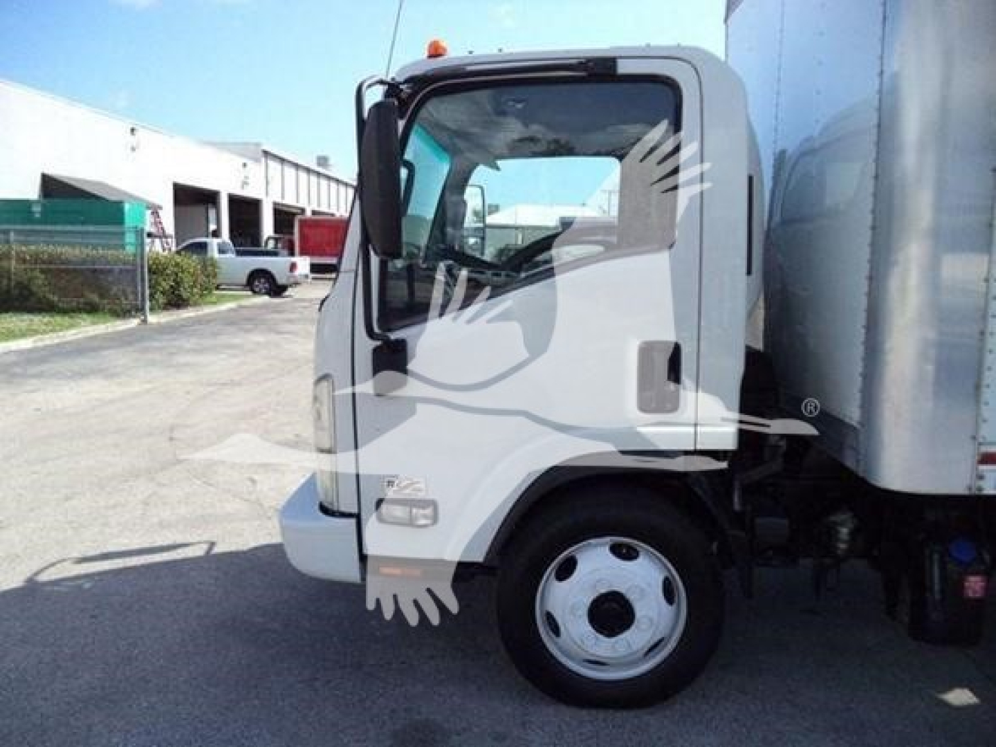 Isuzu NPR/NRR cab and box truck in view showing front-left side of cab and wheel.