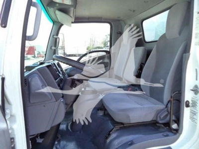 Isuzu NRR truck cab interior with two front seats and steering wheel visible