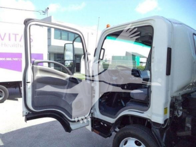 Isuzu NPR/NRR truck cab interior and open door showing steering wheel and dashboard