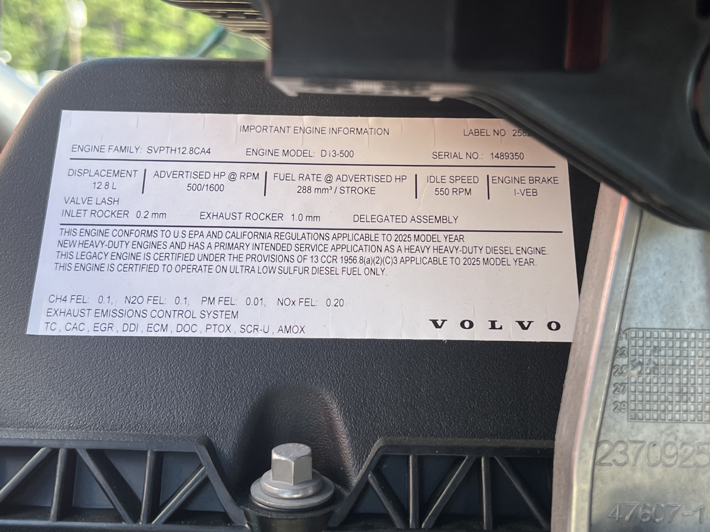Label showing engine information for Volvo engine in a 2026 Volvo VNL64T840. Text includes engine family, engine model, serial number, displacement 12.8 L, fuel rate, idle speed, engine brake, exhaust, etc.