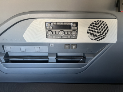Cab interior panel showing control cluster and speaker in Volvo VNL truck door