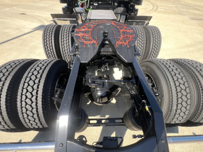  Volvo VNL truck dolly and fifth wheel area showing dual rear axles and drivetrain components undercarriage.