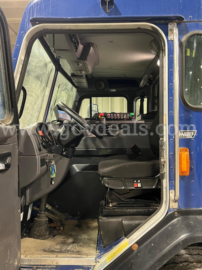 Peterbilt 520 truck cab interior view showing steering wheel, driver's seat, and dashboard with controls.