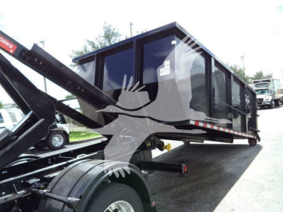 6035 Chevrolet Silverado 6500HD roll-off truck body on trailer showing side window and hydraulic arm; visible logos and general chassis details.