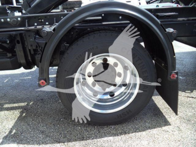Wheel and rear fender area of a 2023 Chevrolet Silverado 6500HD truck chassis showing a single rear wheel with chrome rim and black tire, surrounding frame and mudflap.