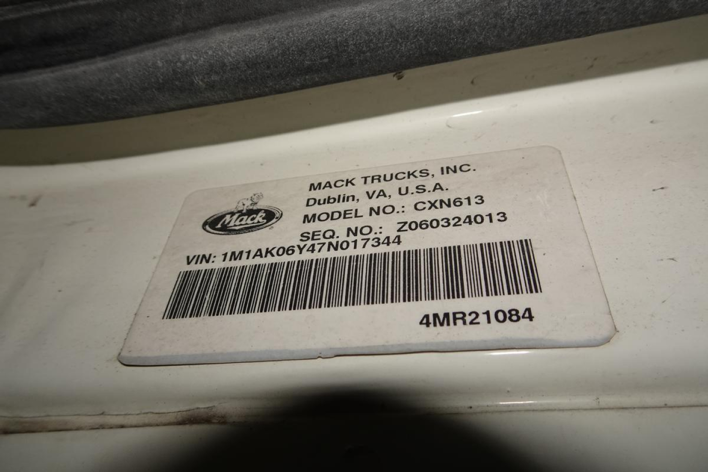 Mack Trucks label on cab showing Mack Trucks, Inc., Dublin VA USA, Model CXN613, VIN 1M1AK06Y47N017344, Seq. No. 260324013, barcode, 4MR21084.