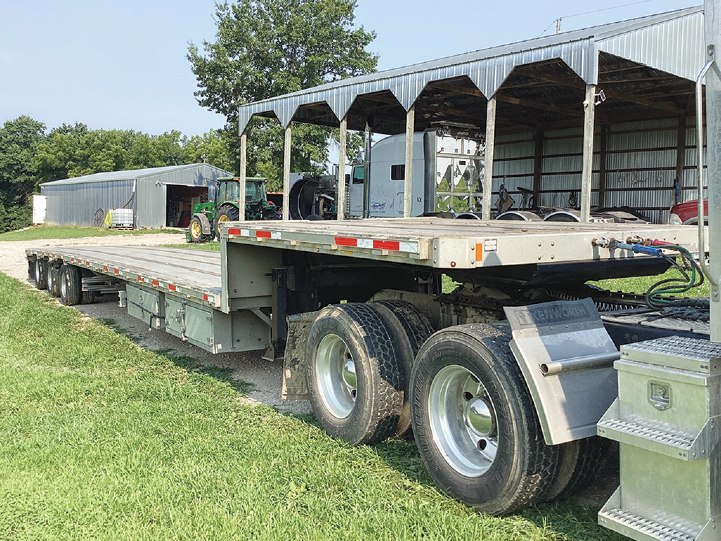 Doonan Platinum trailer in a drop deck configuration, long flatbed with dual rear axles and a secondary platform; appears used with visible tires and equipment undercarriage.