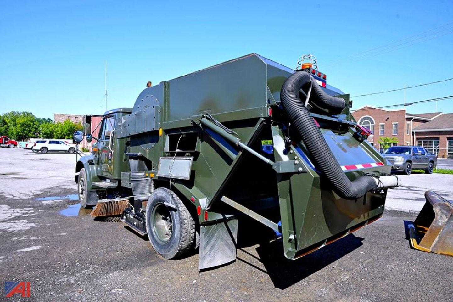 1994 International 4600 sweeper truck rear view showing large hopper and vacuum hose attached