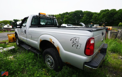 Ford F-250 XL SD Regular Cab pickup truck rear and side view showing 4x4 badge and rust spots on quarter panel.