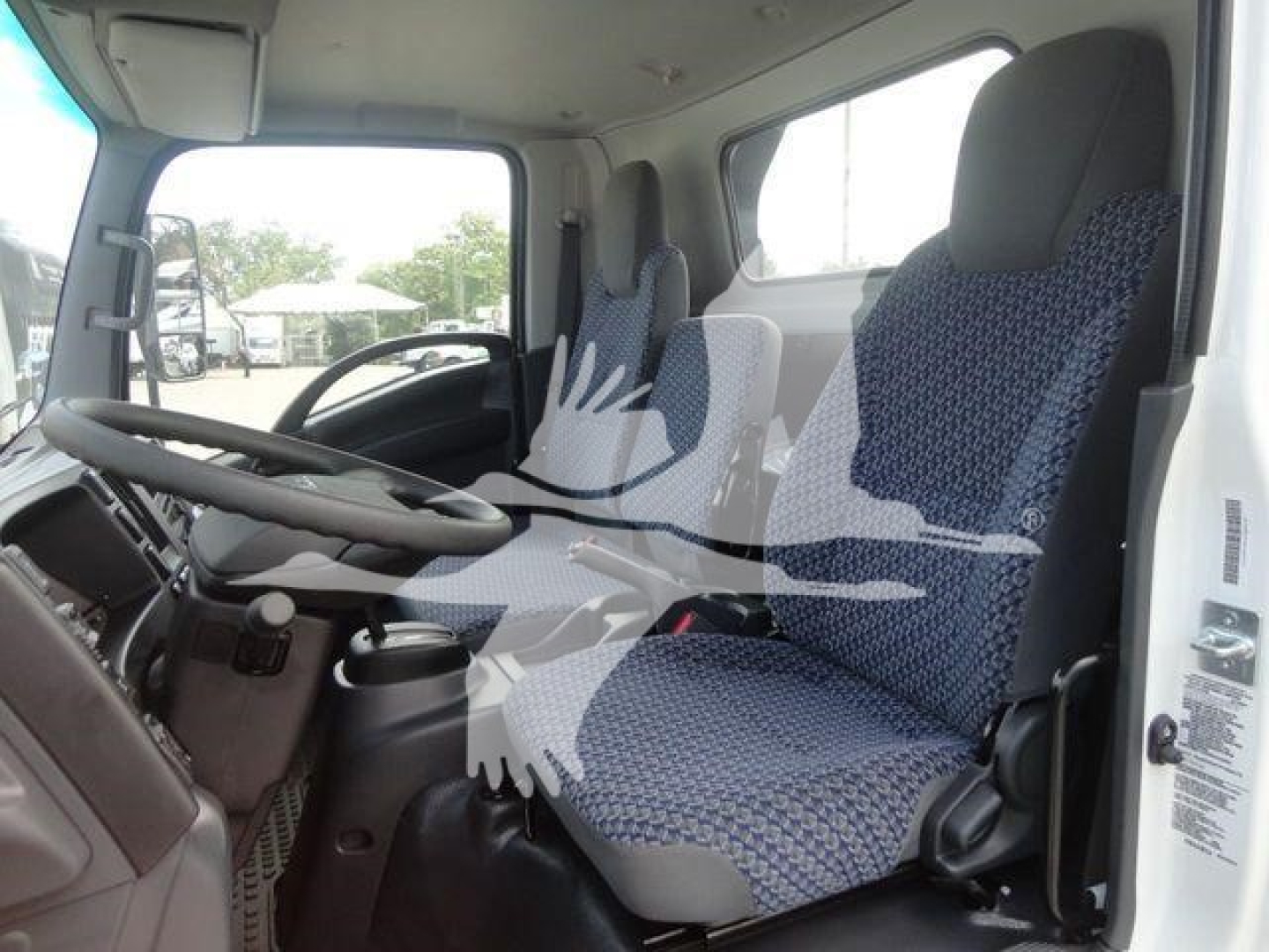 Isuzu NPR/Nrr truck cab interior showing two front seats and steering wheel, dashboard, and door panels.