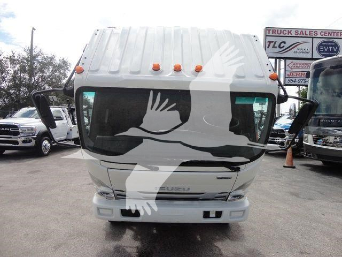 Isuzu NPR-style cab front view with white exterior, rolling back truck, windshield wipers, and multiple small orange roof marker lights.