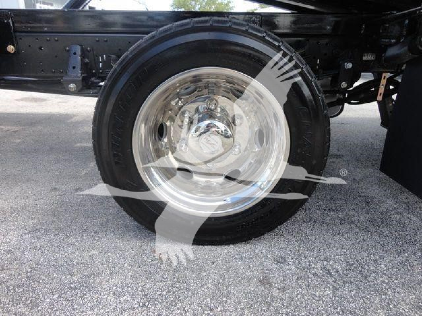 Isuzu NPR/NRR truck rear wheel and suspension showing chrome steel wheel and black tire.