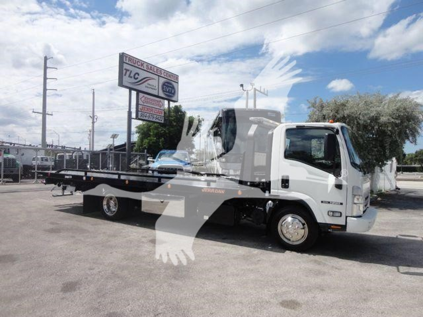 Isuzu NPR/NRR rollback tow truck in white with dual rear wheels and flatbed, parked outdoors; stock number NRRDSL22XLP visible in listing context.