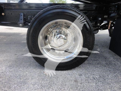 Isuzu NPR/NRR truck rear wheel and suspension showing chrome steel wheel and black tire.