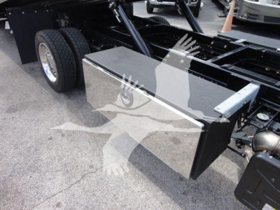 Isuzu NPR/NRR chassis side view showing a rectangular aluminum toolbox mounted near the cab with dual rear wheels and chassis framework in the background.