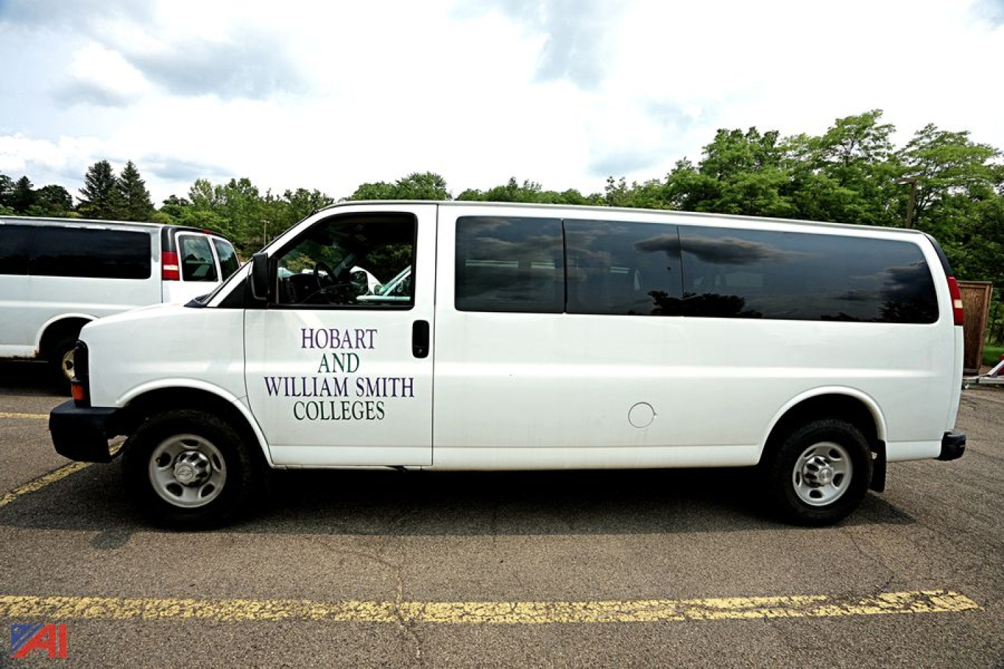 Chevrolet Express extended passenger van side view with 'Hobart and William Smith Colleges' lettering on door.