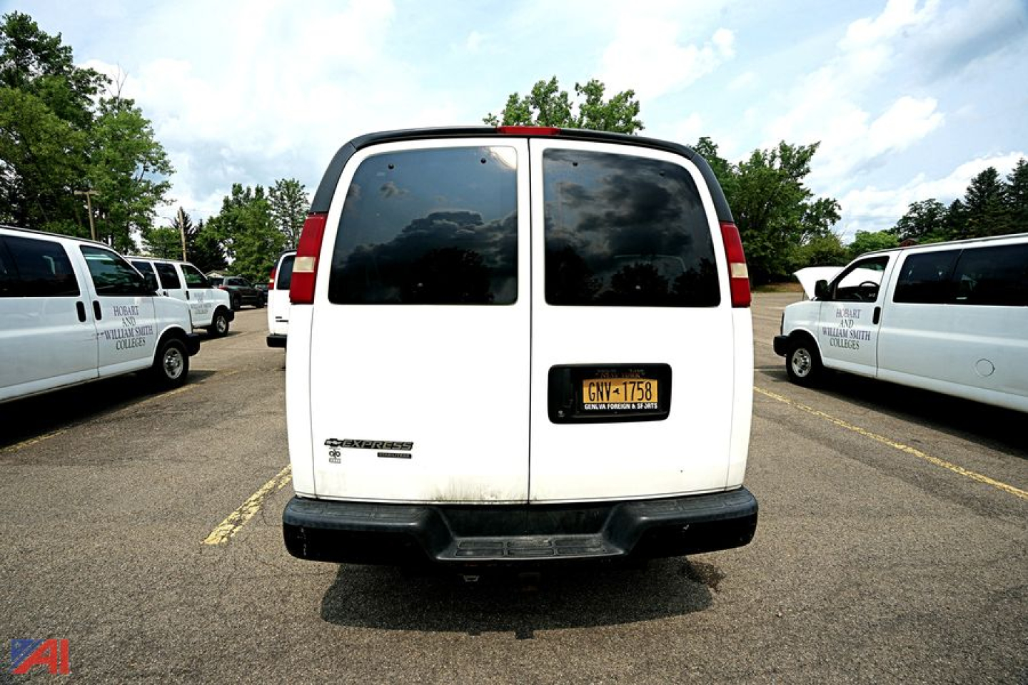 Chevrolet Express Extended 12-Passenger van rear view showing NY license plate and side vans in background