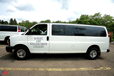 Chevrolet Express extended passenger van side view with 'Hobart and William Smith Colleges' lettering on door.
