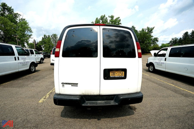 Chevrolet Express Extended 12-Passenger van rear view showing NY license plate and side vans in background