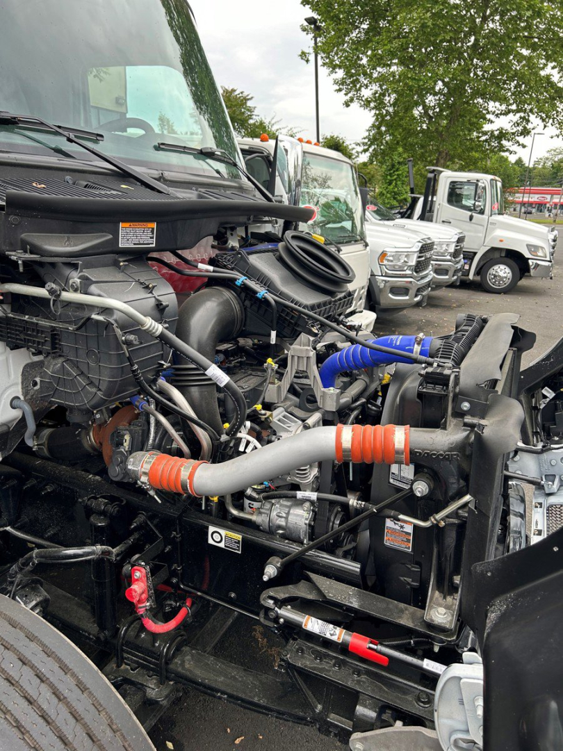 Truck engine bay showing radiator, hoses, and various components in a Kenworth T280 front-end; visible labels on hoses and components