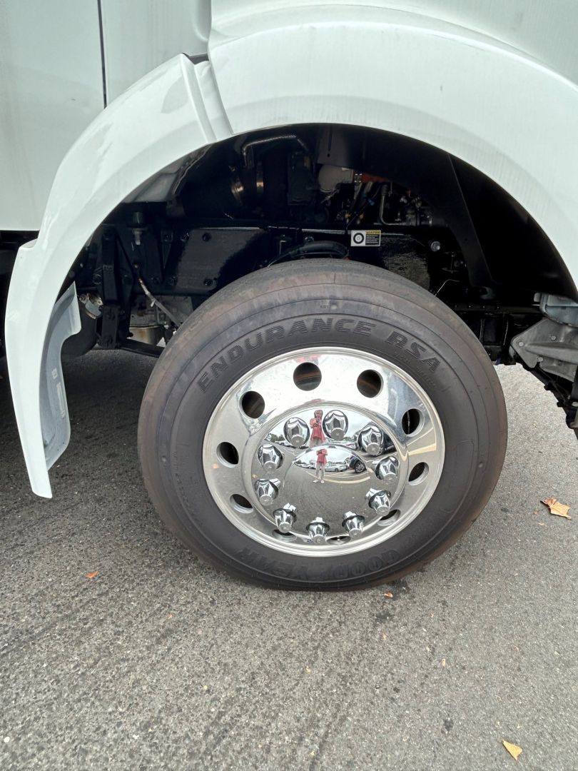 Kenworth T280 front wheel arch and chrome hubcap, tire labeled Endurance A/T, wheel well and parts of suspension visible.