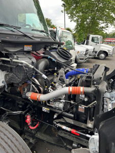 Kenworth T280 engine bay showing turbo hoses, coolant hoses, and various engine components.