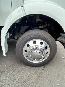 Kenworth T280 front wheel arch and chrome hubcap, tire labeled Endurance A/T, wheel well and parts of suspension visible.