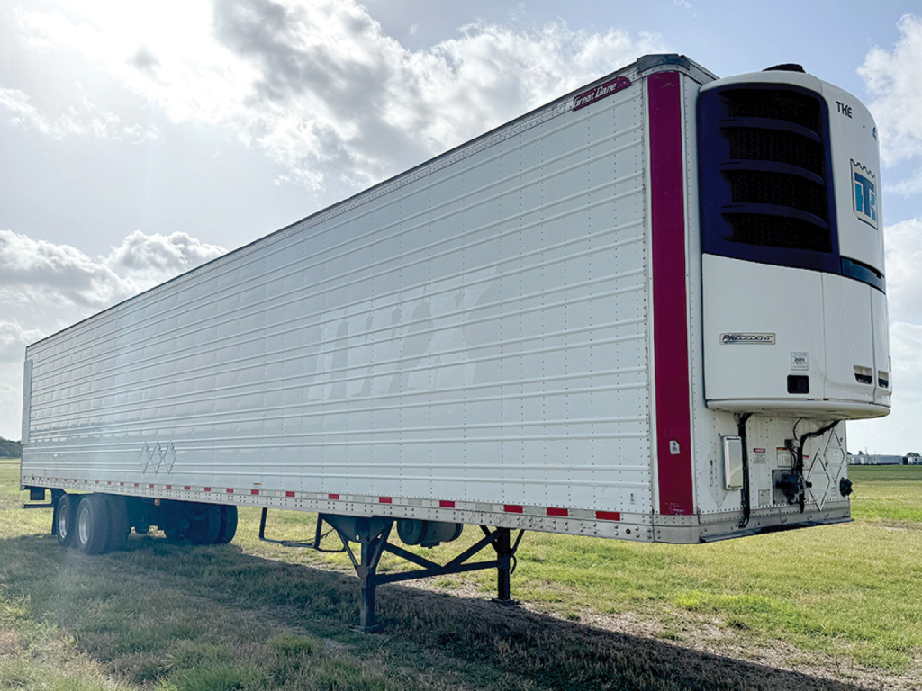Great Dane Everest SS reefer trailer in view showing rear refrigeration unit and long white cargo body with landing gear.