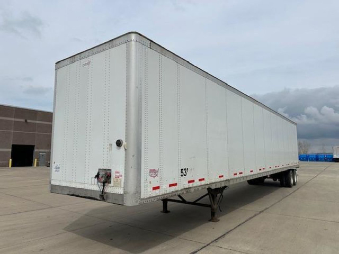 Trailer: 53' Wabash van trailer with front hitch, side riveted panels, and landing gear visible.