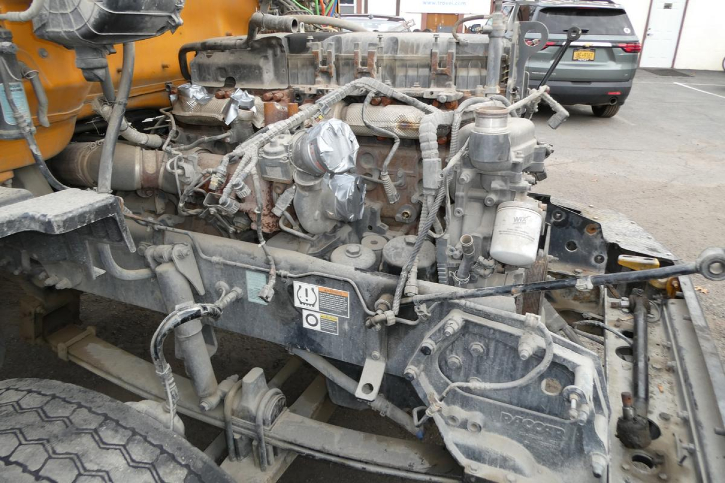 Peterbilt 567 engine bay showing exposed diesel engine and components.